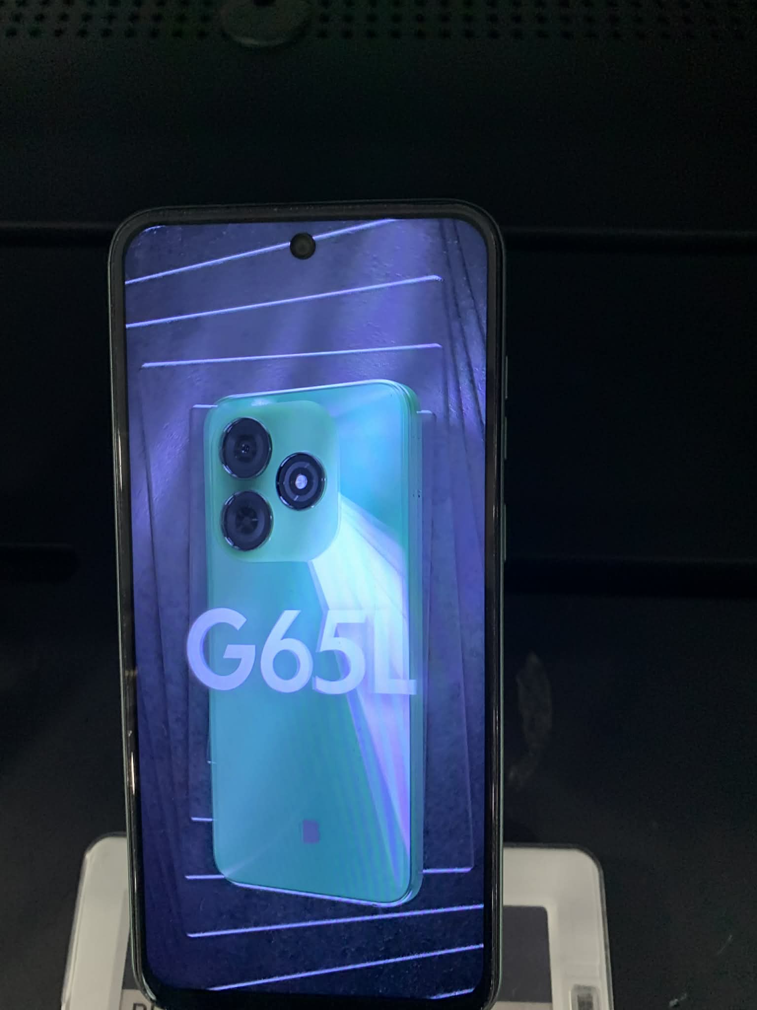 Blu G65L smartphone shown in hand with large 6.5-inch display and triple camera module visible